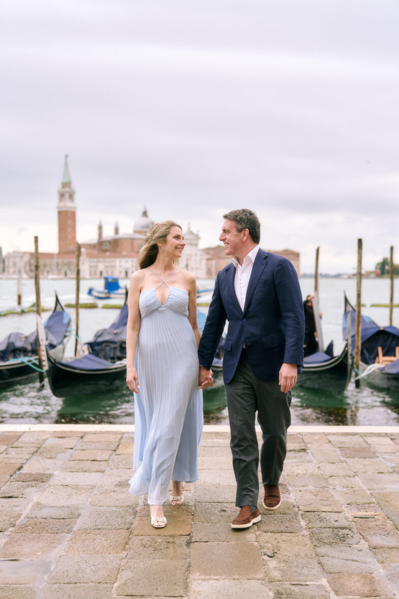 Artistic engagement photo under Venetian arches, editorial vibe captured by Venice engagement photographer.
